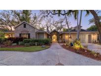 Stone house exterior featuring a covered entryway and landscaping at 3920 Red Rock Way, Sarasota, FL 34231