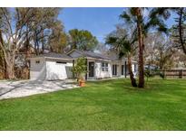 Charming single-story home with manicured lawn, mature landscaping and neutral color palette at 5429 Potter St, Sarasota, FL 34232