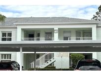 Two-story building exterior with covered parking at 5725 Greenwood Ave # 9103, North Port, FL 34287