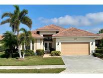 One-story home with tile roof, double doors, and attached garage at 636 Lakescene Drive Dr, Venice, FL 34293