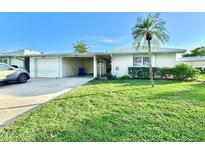 Single-story home with attached garage and well-manicured lawn at 7011 9Th W Ave, Bradenton, FL 34209