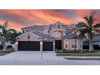 Two-story house with a two-car garage, landscaped yard, and brick facade at 1178 Fraser Pine Blvd, Sarasota, FL 34240