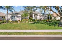 House exterior featuring a well-manicured lawn and inviting front porch at 2305 Little Country Rd, Parrish, FL 34219