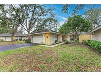 Cute yellow house with a one car garage and well-manicured lawn at 253 Southampton Dr # 298, Venice, FL 34293