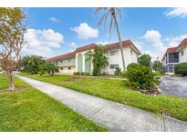 Building exterior showcasing landscaping and parking at 3500 Beneva Rd # 303, Sarasota, FL 34232