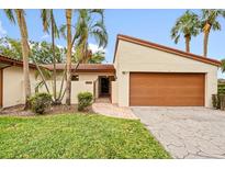 Updated condo exterior with a 1 car garage and lush landscaping at 6401 Pelican Dr # 80A, Bradenton, FL 34210