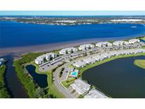 Aerial view of waterfront community with resort-style amenities and parking at 1030 Tidewater Shores Loop # 306, Bradenton, FL 34208