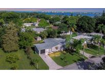 Aerial view of a renovated house with a modern design, situated on a large lot with lush landscaping at 104 24Th Ne St, Bradenton, FL 34208