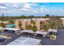 Aerial view of condo building with parking and pool at 1330 Glen Oaks E Dr # 268D, Sarasota, FL 34232