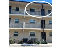 Exterior view of condo building showcasing balcony and parking at 2220 Stickney Point Rd # 537, Sarasota, FL 34231