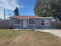 Newly painted gray house with a yard at 5806 15Th W St, Bradenton, FL 34207