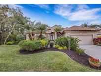 Beautiful home with lush landscaping, a large driveway, and a two-car garage at 6605 Nautical Dr, Lakewood Ranch, FL 34202