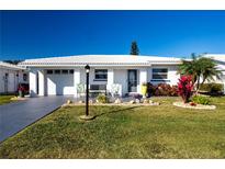 White single-story home with landscaped lawn and driveway at 804 Buttonwood Dr, Bradenton, FL 34208