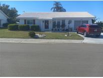 Single-story home with a landscaped lawn and driveway at 1002 Oakleaf Blvd, Bradenton, FL 34208