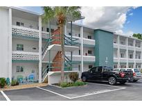Two-story building with teal accents, and parking in front at 1832 Sunny Dr # D32, Bradenton, FL 34207