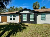 Updated home exterior with fresh paint and landscaping at 2937 N Lockwood Meadows Blvd, Sarasota, FL 34234