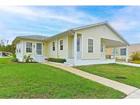 Tan single story home with a covered porch, and well maintained lawn at 4531 13Th E St, Ellenton, FL 34222