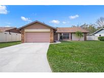 Single-story house with attached garage, and well-maintained lawn at 8469 Cypress Lake Cir, Sarasota, FL 34243