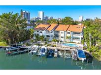 Aerial view of waterfront property with boat slips and a community pool at 866 Hudson Ave # 866, Sarasota, FL 34236