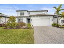 Two-story house with white garage door and landscaped lawn at 12409 Wigeon Dr, Bradenton, FL 34212