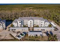 Aerial view of apartment building with parking and surrounding landscape at 14191 Heritage Landing Blvd # 1244, Punta Gorda, FL 33955