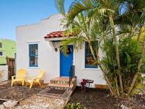 Charming Spanish-style home with bright blue door and lush landscaping at 202 27Th W St, Bradenton, FL 34205