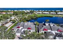 Aerial view of a beautiful home community with waterfront access and lush landscaping at 3465 Winding Oaks Dr # 33, Longboat Key, FL 34228