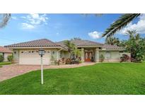 Single-story home with tile roof, 2-car garage, and lush lawn at 462 Rubens E Dr, Nokomis, FL 34275