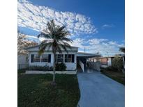 Single-story home with carport and palm tree at 510 50Th Avenue W Dr, Bradenton, FL 34207