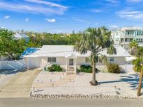 Aerial view of a charming single-story home with a spacious yard and palm tree at 605 Jungle Queen Way, Longboat Key, FL 34228