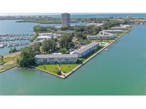 Aerial view of waterfront property with lush landscaping and marina at 777 John Ringling Blvd # 2, Sarasota, FL 34236