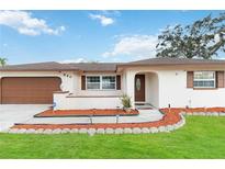 House exterior with landscaped walkway, attached garage, and attractive curb appeal at 320 Whitfield Ave, Sarasota, FL 34243