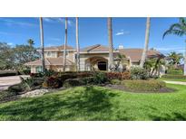 Luxury home with tile roof, manicured landscaping, and palm trees at 4201 Palacio Dr, Sarasota, FL 34238