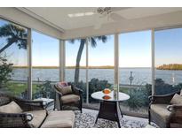 Bright sunroom with water views and comfortable seating at 4310 Falmouth Dr # A104, Longboat Key, FL 34228