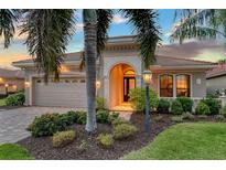 Attractive single-story home with a landscaped yard and a two-car garage at 7312 Riviera Cv, Lakewood Ranch, FL 34202