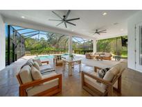 Spacious covered patio with pool and seating area at 14901 17Th E Ave, Bradenton, FL 34212