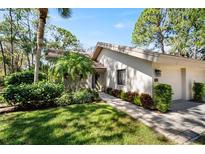 Well-maintained house exterior with landscaped yard and walkway at 3105 Sandleheath # 1, Sarasota, FL 34235