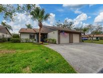 Two-car garage, attractive landscaping, and a spacious driveway at 365 Oak Hill Way # 32, Sarasota, FL 34232