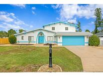 Stunning two-story home with a bright blue garage and nicely landscaped lawn at 5420 4Th Avenue Nw Dr, Bradenton, FL 34209