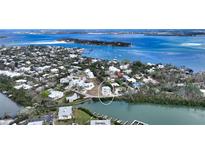 Aerial view of waterfront home with surrounding neighborhood at 625 Jackson Way, Longboat Key, FL 34228