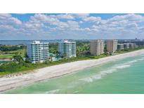 Aerial view of beachfront condos with ocean and city views at 675 Longboat Club Rd # 22A, Longboat Key, FL 34228