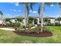 White two-story house with gray roof, landscaping, and walkway at 7117 River Club Blvd, Bradenton, FL 34202