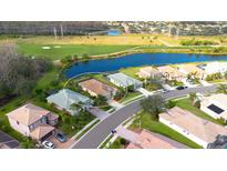 Aerial view of single-Gathering home on a golf course community with a pond at 8752 Monterey Bay Loop, Bradenton, FL 34212