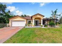 Charming single-story home with a landscaped yard and attached garage at 20255 Macon Ln, Port Charlotte, FL 33952