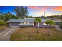 Updated ranch home with a landscaped yard and driveway at 2523 Darwin Ave, Sarasota, FL 34239