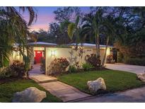 Attractive home with red door, landscaped yard, and walkway at 3414 Old Oak Dr, Sarasota, FL 34239