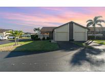 Two-story condo with attached garage, and lush landscaping at 3920 Bal Harbor Blvd # E1, Punta Gorda, FL 33950
