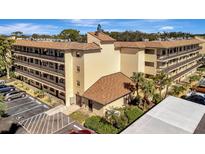 Condo building with multiple units, ample parking, and lush landscaping at 435 30Th W Ave # D309, Bradenton, FL 34205