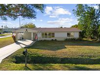 Charming ranch home with landscaped lawn and driveway at 6116 Rodgers Ave, Sarasota, FL 34231