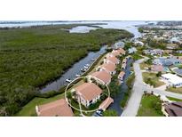 Aerial view of waterfront condo community, highlighting a specific unit and shared pool at 8644 54Th W Ave # 8644, Bradenton, FL 34210